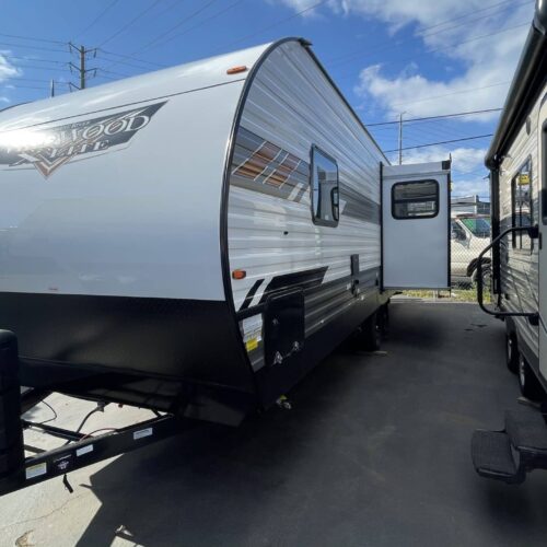 2022 FOREST RIVER WILDWOOD 25RKS slide-out trailer. From Forest River's #1 selling brand, Wildwood, this rear kitchen model is a best seller. It features a big rear kitchen, mid-living room with a huge dinette slide-out and a couch, and fireplace. The front queen bedroom has it's own door for privacy.