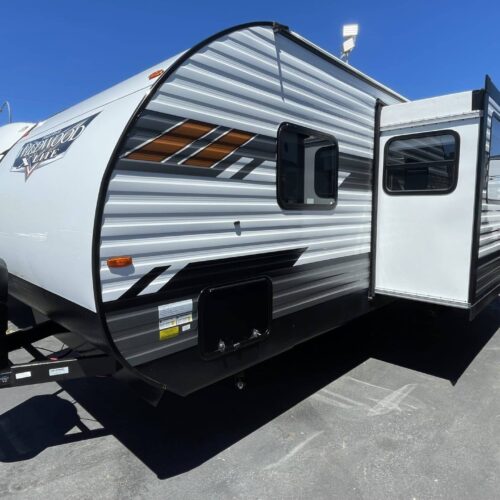 2022 WILDWOOD 263 BHXL w/ Bunk Beds. The quintessential bunkhouse floor plan from Forest River’s #1 selling trailer brand: WILDWOOD. The 263 features an outside kitchen. The trailer has a front queen bedroom with a solid door, a large wall for a TV and pass-thru storage under the bed. The living area has an electric “fireplace”, a super-slide w/ U-shaped dinette with drawers under the dinette seats, a comfortable “versa-lounger ”couch with storage bins underneath, a big kitchen with a solid surface kitchen counter with a flip-up counter extension. Rear bunk beds are “double wide” for extra room or sleeping a couple of kids, windows on both bunks, and USB charger ports. The bathroom features a separate exterior door. No more running through the whole trailer to get to the bathroom! Outside features the upgraded "solid step" entrance step, upgraded "strong arm" stabilizer jacks, electric awning, electric tongue jack, and a friction hinge entrance door.