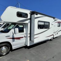 2012 COACHMEN FREELANDER 29QB Class C motorhome. The Freelander 29QB is a classic Class C floor plan with a mid-kitchen, front dinette across from a couch and a rear Island queen bedroom. The coach features an exterior of gelcoat fiberglass the really shines, a slide topper awning, electric main awning, and lots of pass-thru basement storage.