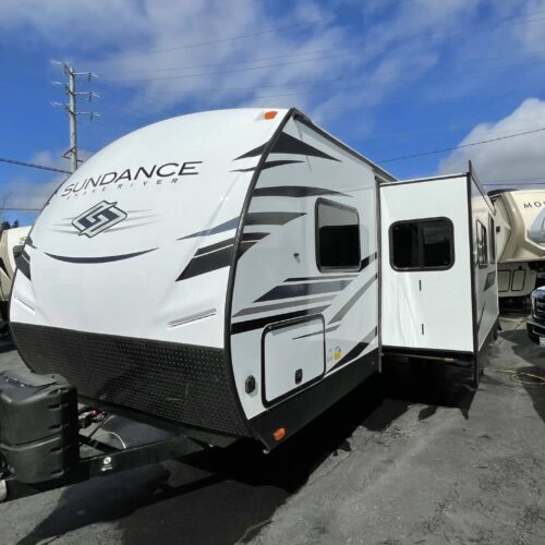 2022 HEARTLAND SUNDANCE 291QB trailer. ***One Only at This Price***Sundance is Heartland's Ultra-Lite trailer line with aluminum frame / bonded wall construction and an enclosed/heated underbelly for extended season camping and a 3-year structural warranty. The 291QB features a separate rear QUAD bunk room with 3 bunks and a dinette that drops down into the 4thbunk. The bunk room has a closet w/ drawers and a solid door for privacy. The slide-out holds an extra wide dinette and a couch/hid-a-bed that is very comfortable as a couch or as a bed. The big flatscreen TV is mounted in the living room. The interior kitchen features an extra large sink and an oven and microwave. The outside kitchen features a refrigerator, and a solid top grill. The outside features fiberglass sidewalls, electric stab jacks, electric tongue jack, Mor-Ride “solid to the ground” entrance step, pass thru basement storage and an enclosed/heated underbelly.