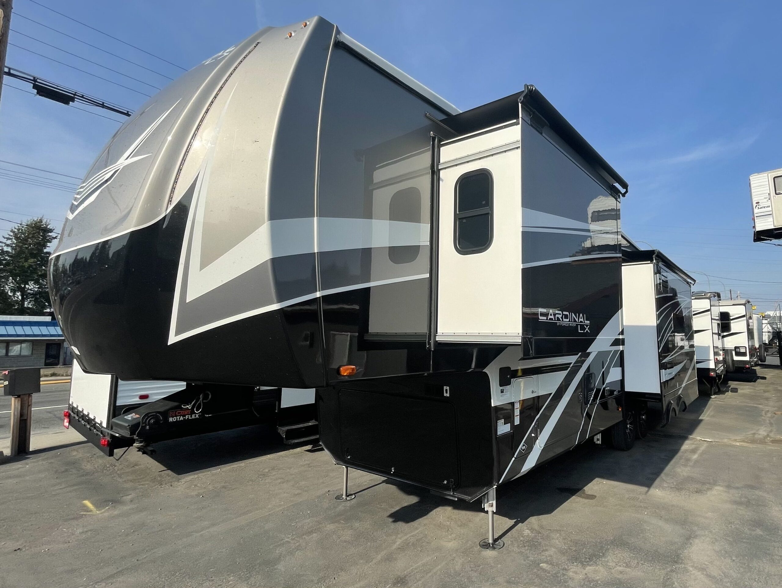 2023 Cardinal Luxury 320RL. Full painted edition from Forest River's Cardinal Luxury Line. The 320RL is a beautiful full time quality, 4-season fifth wheel, that keeps you at about 36' overall. The rear living room features a hide a bed couch and theatre style recliners across from the flat screen TV. The mid kitchen has residential style appliances, including a huge oven, double stainless sink in the kitchen island, a "walk in" pantry and quad-door refrigerator. The king size bedroom has a master bathroom with a huge shower. There is a washer/dryer prep in one of the closets. The outside features a huge front storage bay, 6 point auto leveling jacks and a beautiful full painted exterior.