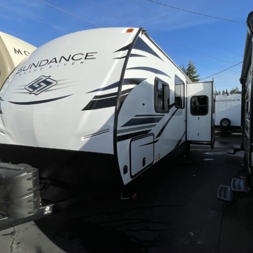 NEW 2022 SUNDANCE SNAKE RIVER Edition 242RK Ultra Lite. ***One Only at This Price***The Sundance 242RK features a big rear kitchen with lots of windows, an entertainment center with theatre seating couch across from the pop-up TV, a spacious bathroom and a bedroom with a second entrance door. he interior is light and bright. The Sundance trailers have a 3 -year structural warranty and are loaded with features including: enclosed and heated tanks, aluminum framing with laminated fiberglass sidewalls, “slam-latch” baggage doors, electric tongue jack, MorRide “step-above” entrance steps (500lb rated), fiberglass front cap, barreled interior ceiling (6’9” overall height) and prepped for solar and backup camera.